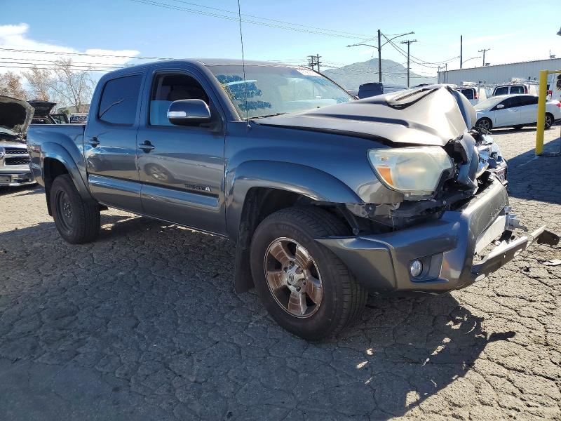 Totaled pickup truck with front-end collision damage at a salvage lot
